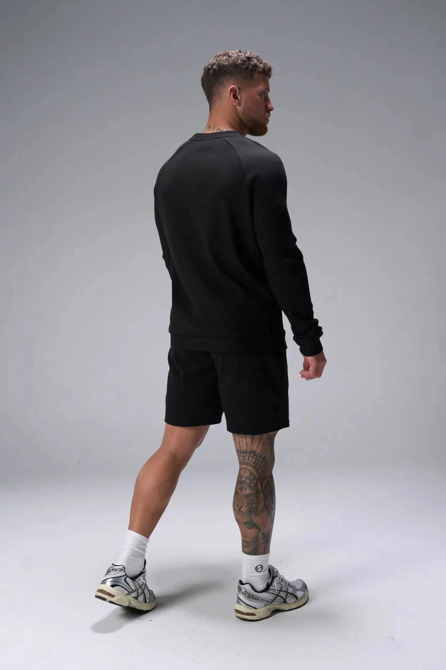 Side View of Black the TLF Waffle Tech Crew Neck featuring a raglan sleeve in our premium waffle knit fabric