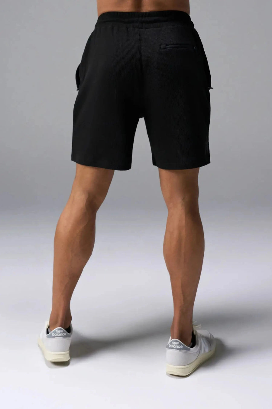Back View of Black TLF GTS Waffle Tech Shorts, featuring a 6” Inch inseam, an athletic relaxed fit with zipper pockets designed for all day wear