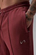 Front View of Red the TLF GTS Waffle Tech Straight Leg Pants featuring pintuck detailing, zippered pockets and straight leg design