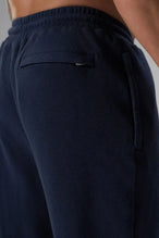 Back View of Blue the TLF GTS Waffle Tech Straight Leg Pants featuring pintuck detailing, zippered pockets and straight leg design