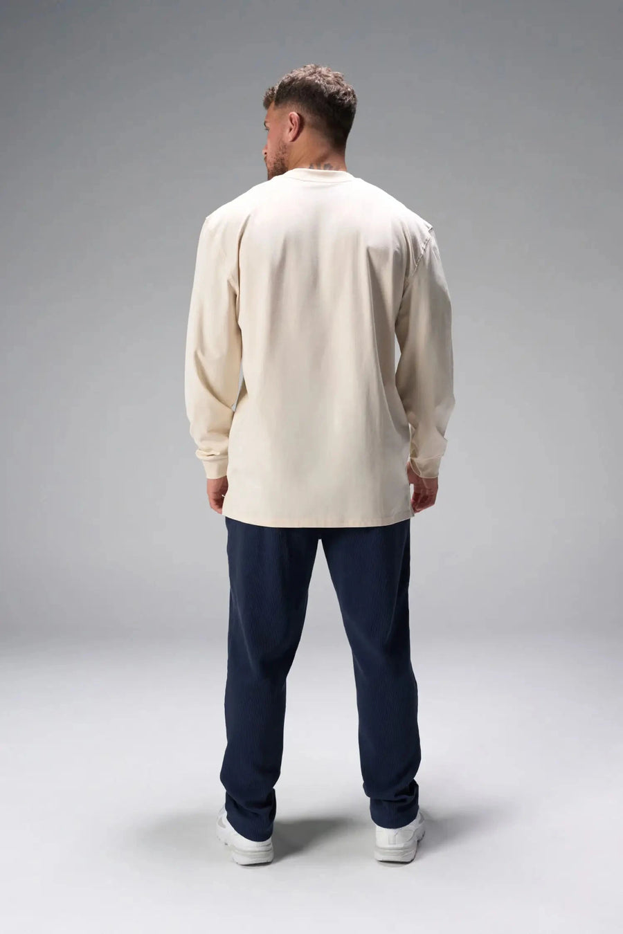 Back View of Blue the TLF GTS Waffle Tech Straight Leg Pants featuring pintuck detailing, zippered pockets and straight leg design