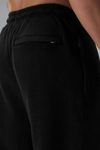 Back View of Black the TLF GTS Waffle Tech Straight Leg Pants featuring pintuck detailing, zippered pockets and straight leg design