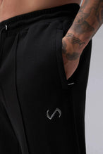 Front View of Black the TLF GTS Waffle Tech Straight Leg Pants featuring pintuck detailing, zippered pockets and straight leg design