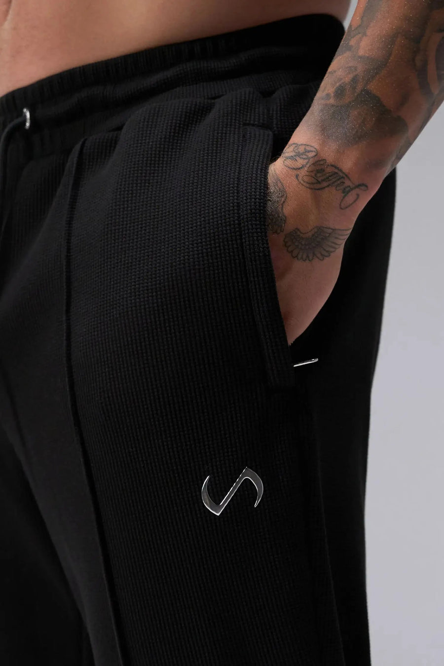 Front View of Black the TLF GTS Waffle Tech Straight Leg Pants featuring pintuck detailing, zippered pockets and straight leg design
