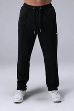 Front View of Black the TLF GTS Waffle Tech Straight Leg Pants featuring pintuck detailing, zippered pockets and straight leg design