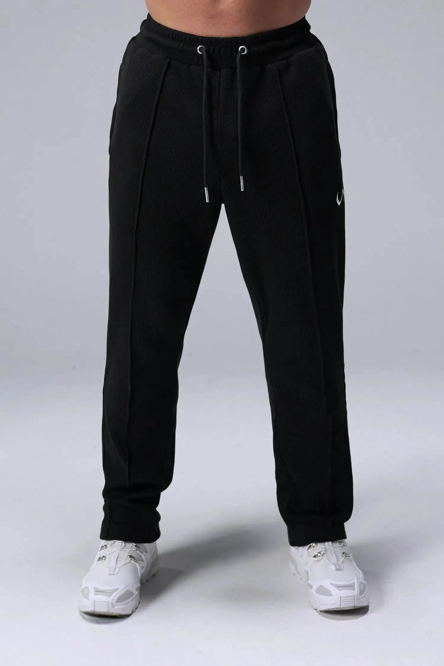Front View of Black the TLF GTS Waffle Tech Straight Leg Pants featuring pintuck detailing, zippered pockets and straight leg design
