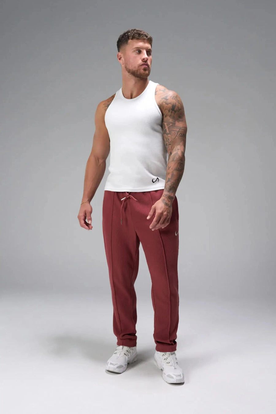 Front View of Red the TLF GTS Waffle Tech Straight Leg Pants featuring pintuck detailing, zippered pockets and straight leg design