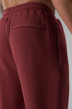 Back View of Red the TLF GTS Waffle Tech Straight Leg Pants featuring pintuck detailing, zippered pockets and straight leg design