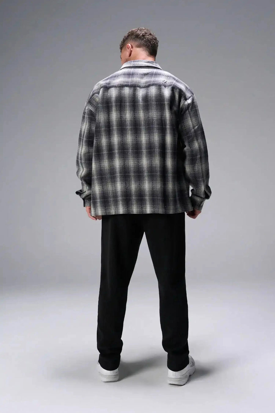 Back View of Black the TLF GTS Waffle Tech Straight Leg Pants featuring pintuck detailing, zippered pockets and straight leg design
