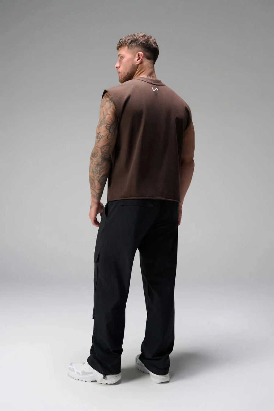Back View of Brown the TLF Icon Muscle Tank featuring our physique enhancing design, straight hem and relaxed fit. 