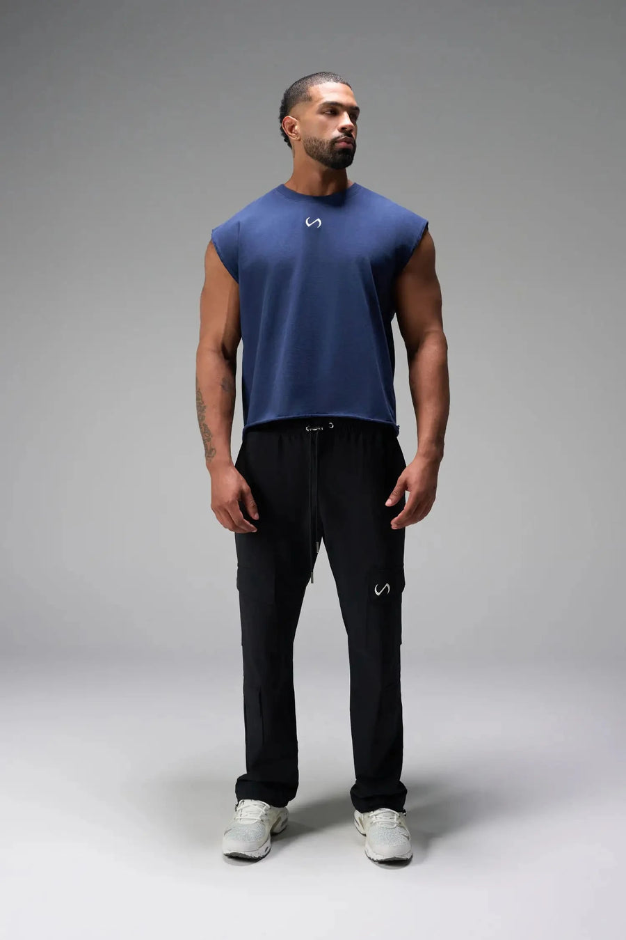 Front View of Blue the TLF Icon Muscle Tank featuring our physique enhancing design, straight hem and relaxed fit. 