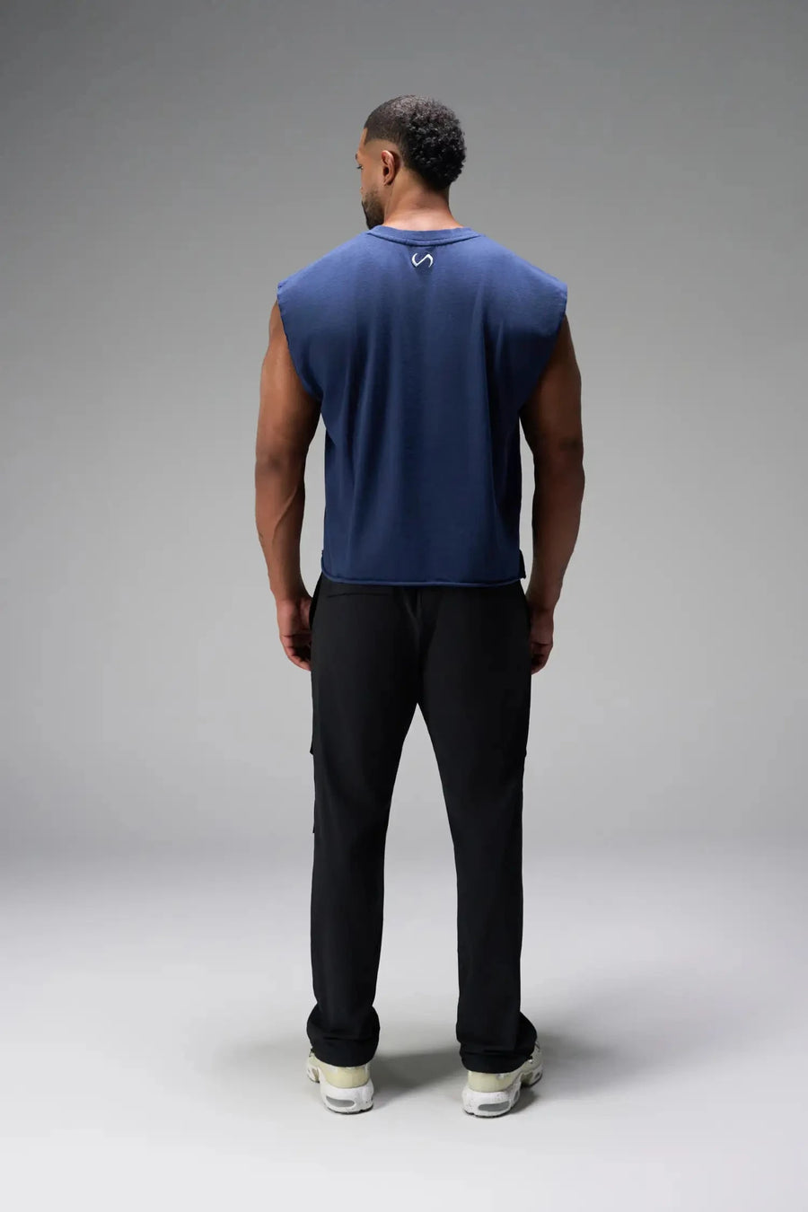 Back View of Blue the TLF Icon Muscle Tank featuring our physique enhancing design, straight hem and relaxed fit. 