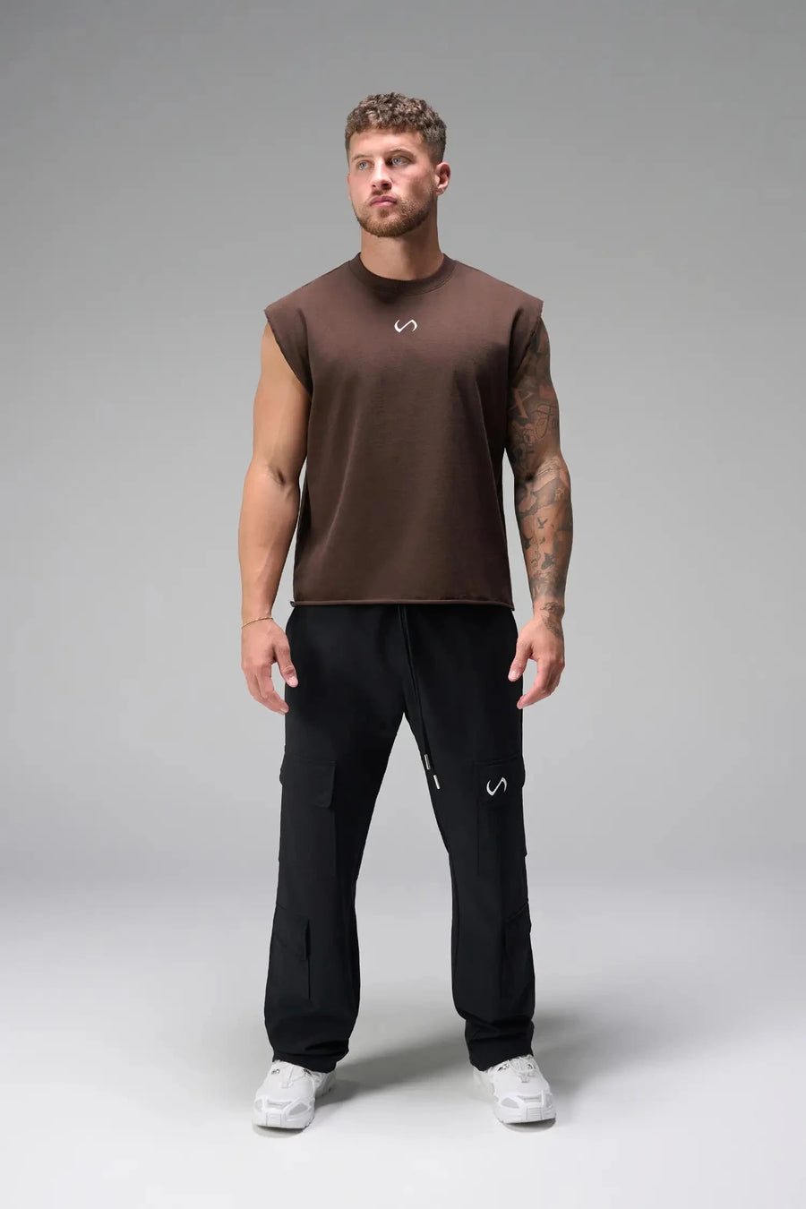 Front View of Brown the TLF Icon Muscle Tank featuring our physique enhancing design, straight hem and relaxed fit. 