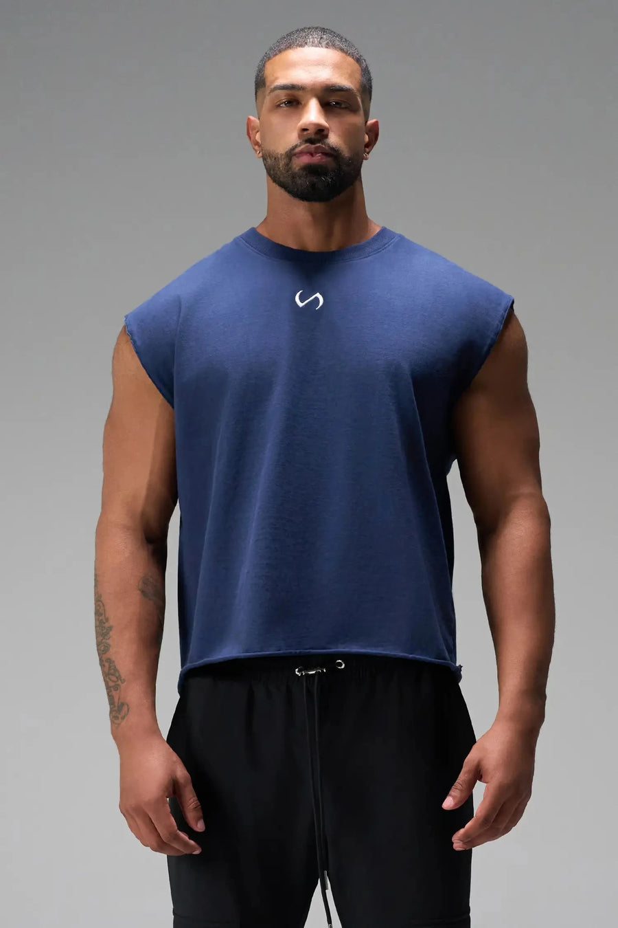 Front View of Blue the TLF Icon Muscle Tank featuring our physique enhancing design, straight hem and relaxed fit. 