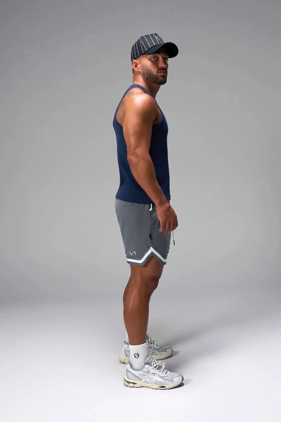 Side View of Blue Icon Ribbed Straight Hem Tank featuring our physique enhancing design, straight hem and relaxed fit