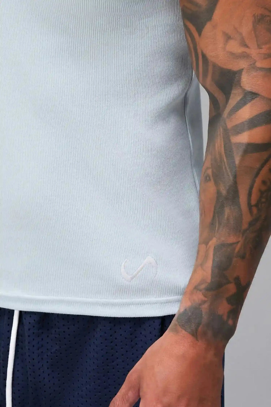 Detail View of Light Blue Icon Ribbed Straight Hem Tank featuring our physique enhancing design, straight hem and relaxed fit