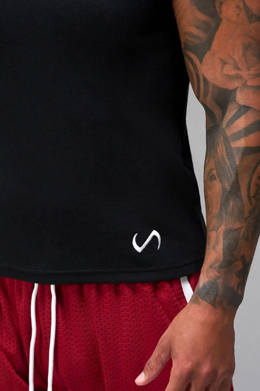 Detail Front View of Black Icon Ribbed Straight Hem Tank featuring our physique enhancing design, straight hem and relaxed fit