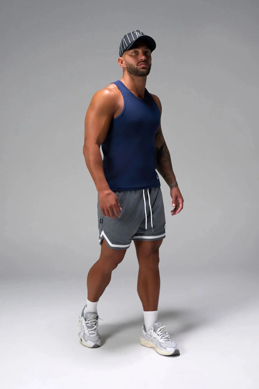 Side View of Blue Icon Ribbed Straight Hem Tank featuring our physique enhancing design, straight hem and relaxed fit
