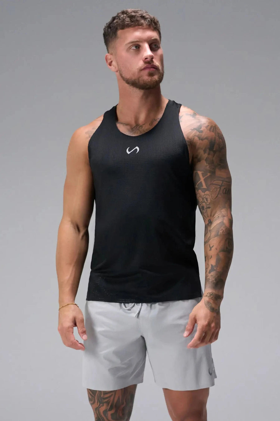 Front View of Black the TLF Infi Cool workout tank engineered with infi cool DNA cooling fabric technology, laser cut mesh holes and perforations