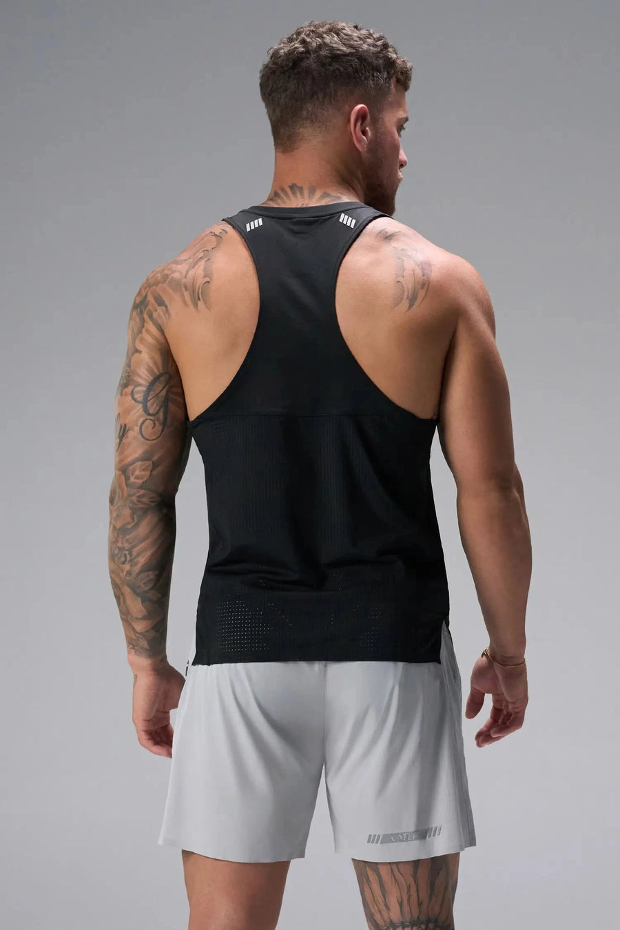 Back View of Black the TLF Infi Cool workout tank engineered with infi cool DNA cooling fabric technology, laser cut mesh holes and perforations