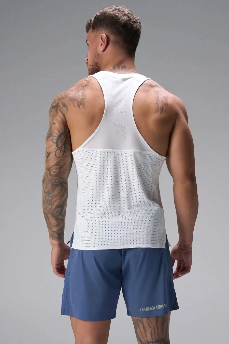 Back View of White the TLF Infi Cool workout tank engineered with infi cool DNA cooling fabric technology, laser cut mesh holes and perforations