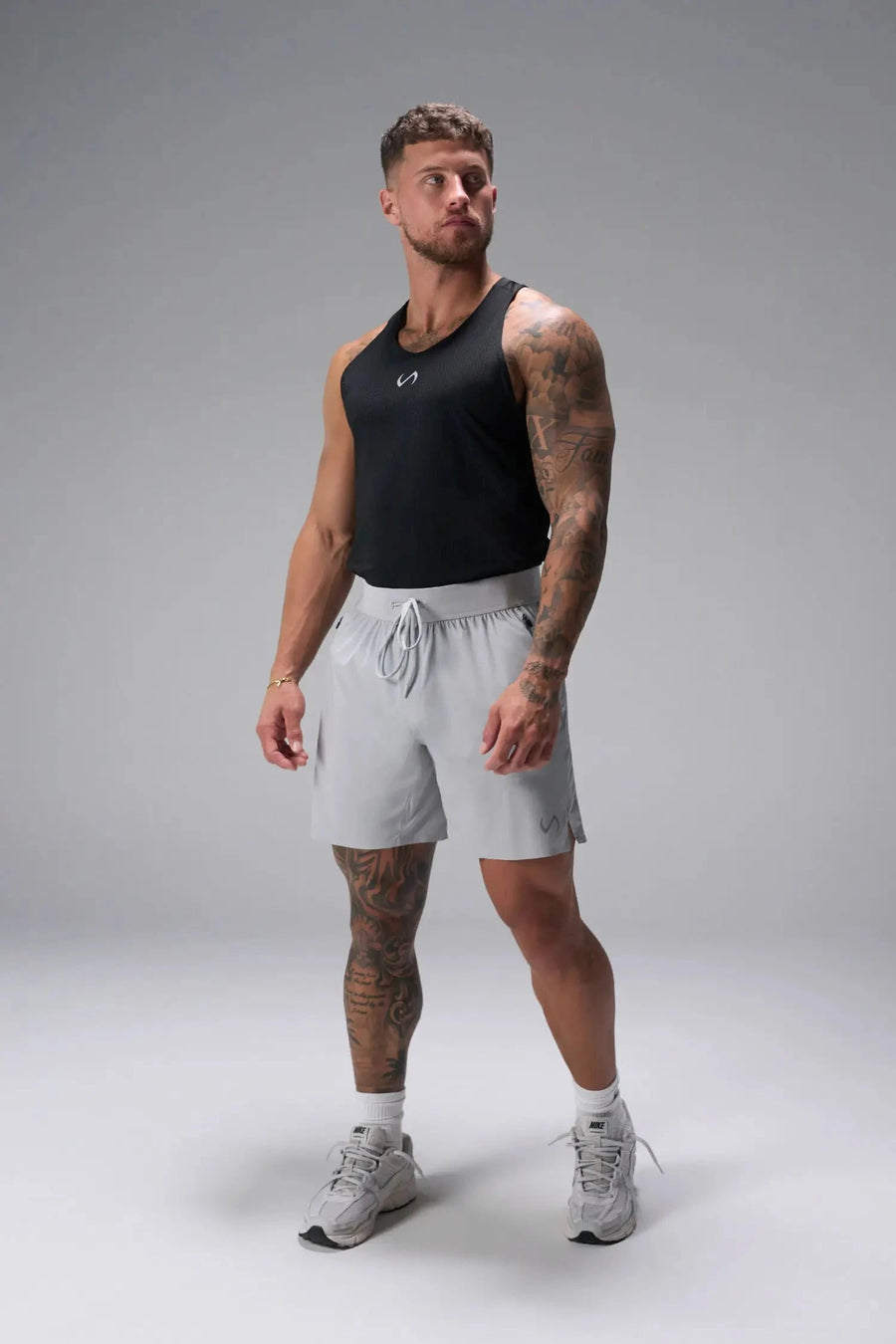 Front View of Black the TLF Infi Cool workout tank engineered with infi cool DNA cooling fabric technology, laser cut mesh holes and perforations