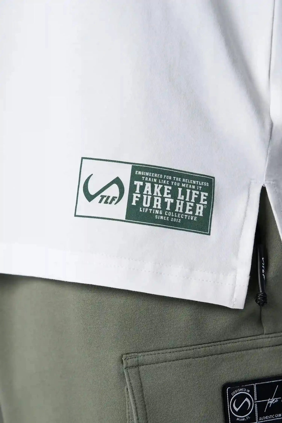 Front view of White TLF Iron Bros Cotton Luxe Oversized Tee featuring “cooling shirt” technology with a 2-tone graphic print across the chest.  