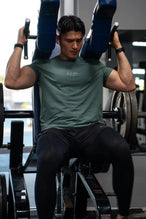 Front View of Green TLF Lifting Team Cotton Luxe Swole Tee, a gym shirt with a physique enhancing fit and a tonal graphic print 