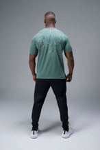 Back View of Green TLF Lifting Team Cotton Luxe Swole Tee, a gym shirt with a physique enhancing fit and a tonal graphic print 