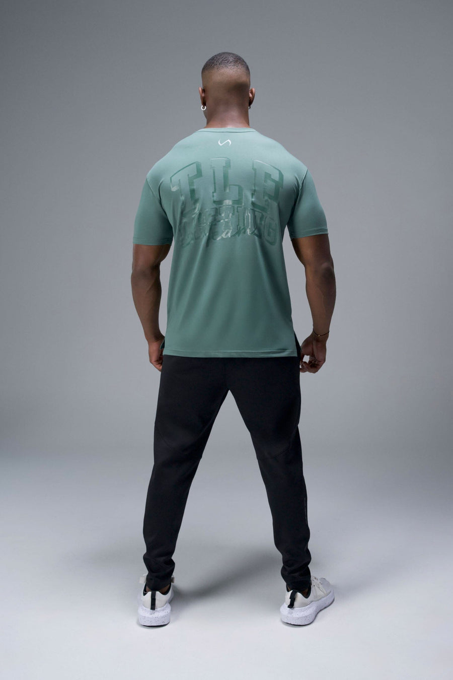 Back View of Green TLF Lifting Team Cotton Luxe Swole Tee, a gym shirt with a physique enhancing fit and a tonal graphic print 