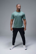Front View of Green TLF Lifting Team Cotton Luxe Swole Tee, a gym shirt with a physique enhancing fit and a tonal graphic print 