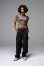 Front View of Black the TLF Low Rise Oversized Cargo Joggers featuring a low-rise waistline, oversized & baggy fit and snap button cargo pockets