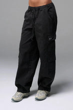 Front View of Black the TLF Low Rise Oversized Cargo Joggers featuring a low-rise waistline, oversized & baggy fit and snap button cargo pockets