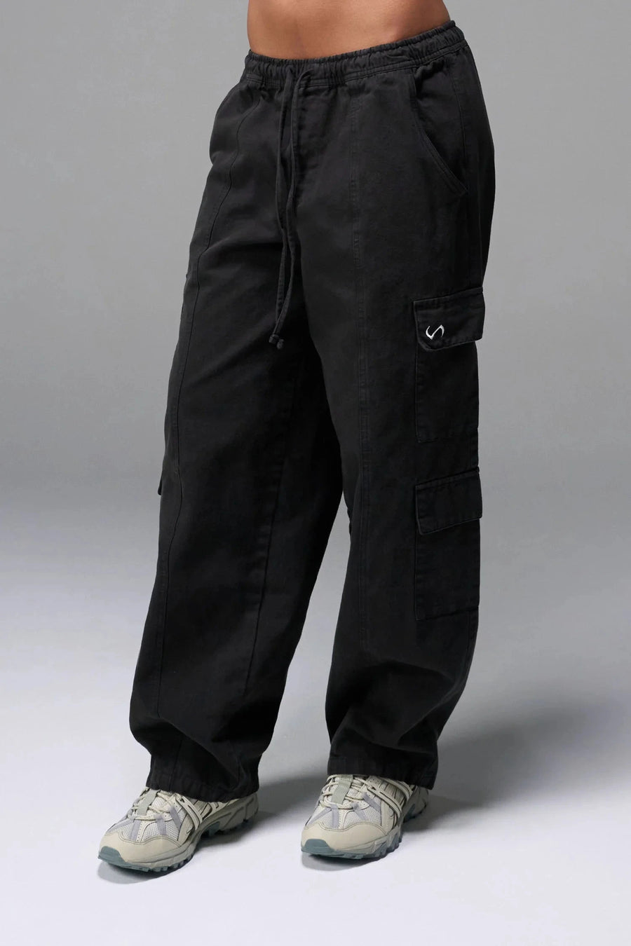 Front View of Black the TLF Low Rise Oversized Cargo Joggers featuring a low-rise waistline, oversized & baggy fit and snap button cargo pockets