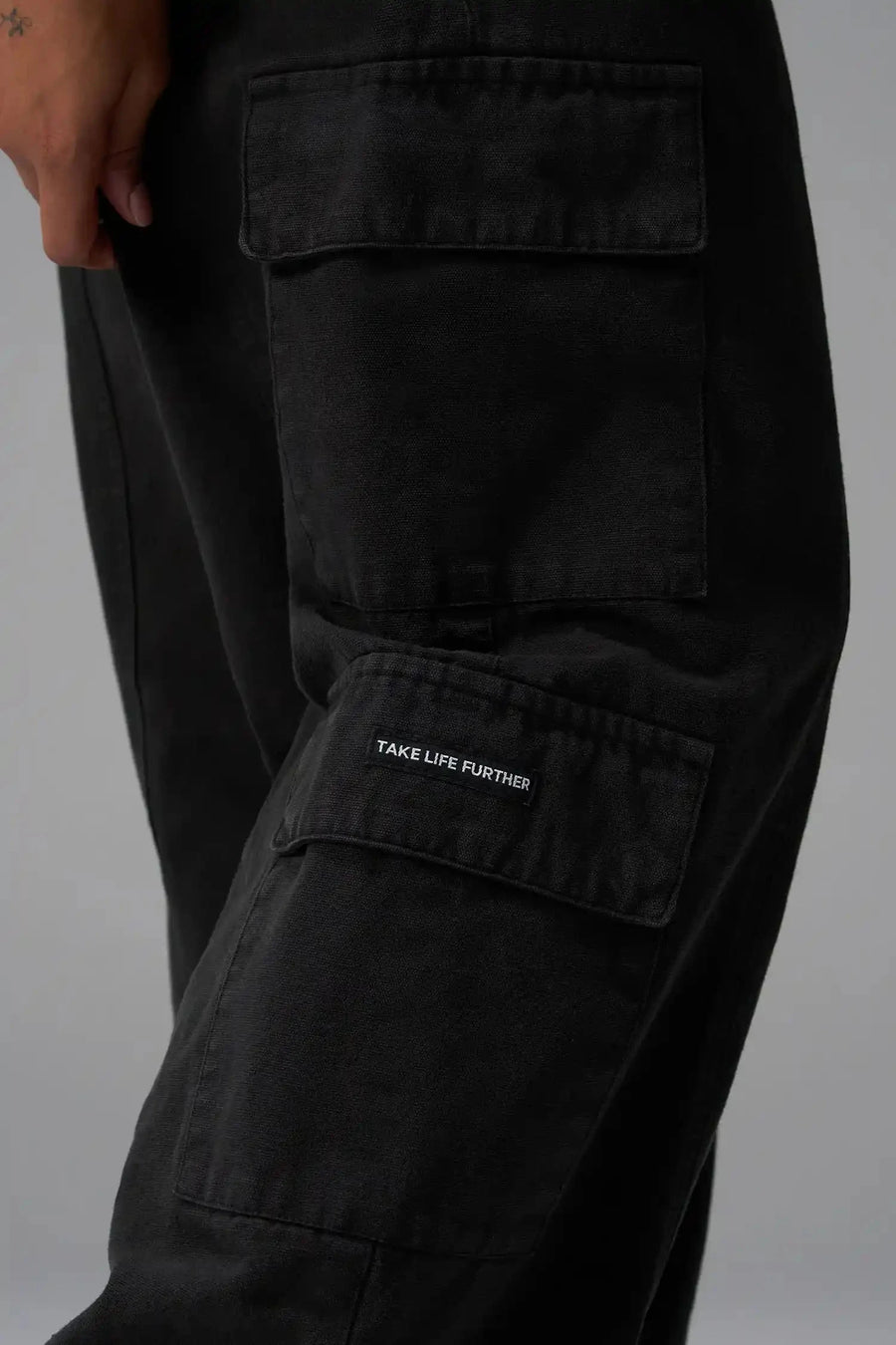 Back View of Black the TLF Low Rise Oversized Cargo Joggers featuring a low-rise waistline, oversized & baggy fit and snap button cargo pockets
