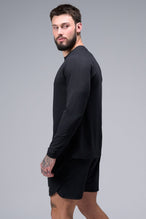 Left Side View of Black TLF Micro Mesh Long Sleeve Shirt, featuring raglan sleeves in Micro Mesh Fabric for breathability and performance