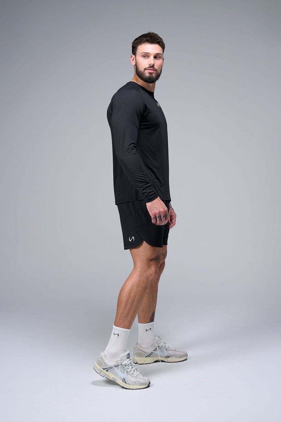 Right Side View of Black TLF Micro Mesh Long Sleeve Shirt, featuring raglan sleeves in Micro Mesh Fabric for breathability and performance