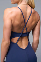 Back View of Blue TLF NeoCloud™ Flare Jumpsuit featuring a built-in low support sports bra with removable pads and adjustable straps