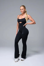 Front View of Black TLF NeoCloud™ Flare Jumpsuit featuring a built-in low support sports bra with removable pads and adjustable straps