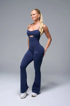 Front View of Blue TLF NeoCloud™ Flare Jumpsuit featuring a built-in low support sports bra with removable pads and adjustable straps
