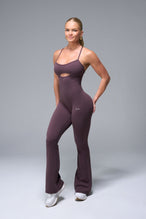 Front View of Brown TLF NeoCloud™ Flare Jumpsuit featuring a built-in low support sports bra with removable pads and adjustable straps