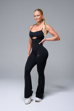 Front View of Black TLF NeoCloud™ Flare Jumpsuit featuring a built-in low support sports bra with removable pads and adjustable straps