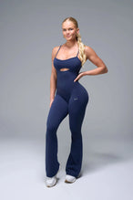 Front View of Blue TLF NeoCloud™ Flare Jumpsuit featuring a built-in low support sports bra with removable pads and adjustable straps