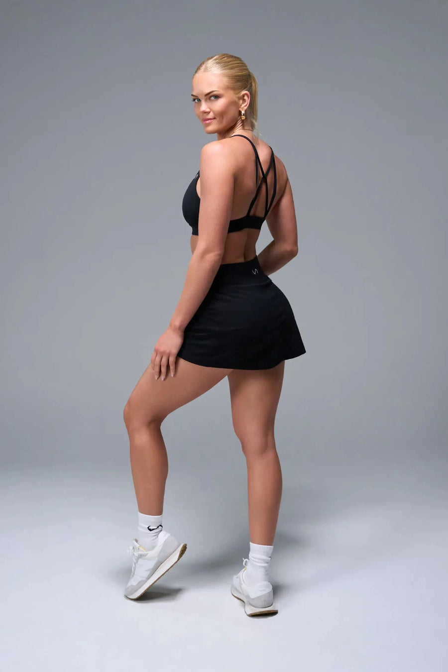 Side View of Black TLF NeoCloud™ workout skirt featuring built in 2.5-inch inseam shorts and side pockets