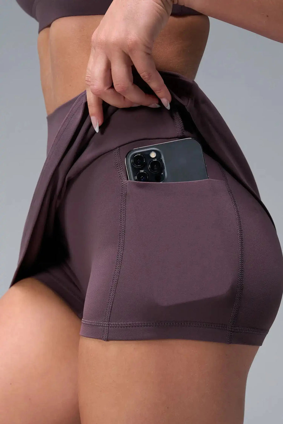 Detail View of Brown TLF NeoCloud™ workout skirt featuring built in 2.5-inch inseam shorts and side pockets