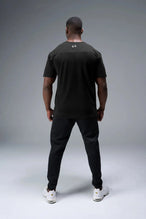 Back View of Black TLF Property of Cotton Luxe Oversized Tee featuring a distressed graphic print design across the chest in our oversized t shirt fit