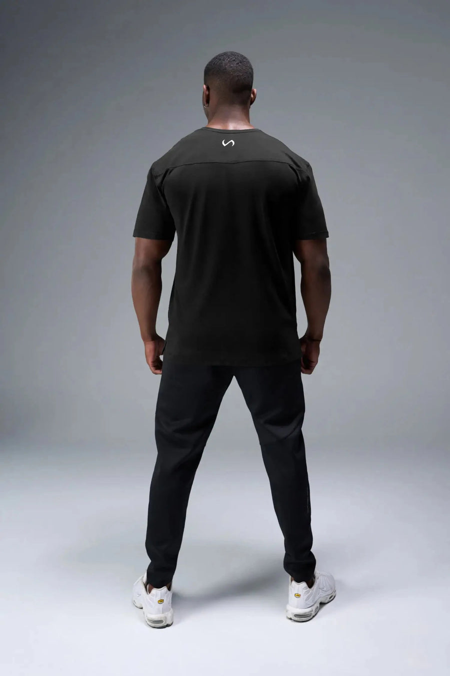 Back View of Black TLF Property of Cotton Luxe Oversized Tee featuring a distressed graphic print design across the chest in our oversized t shirt fit