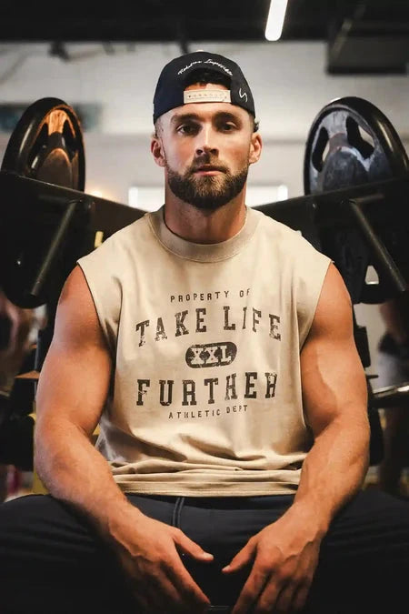 Front View of Tan TLF Property Of Heavy Cotton Muscle Tank featuring a distressed graphic design and raw edge arm holes. 