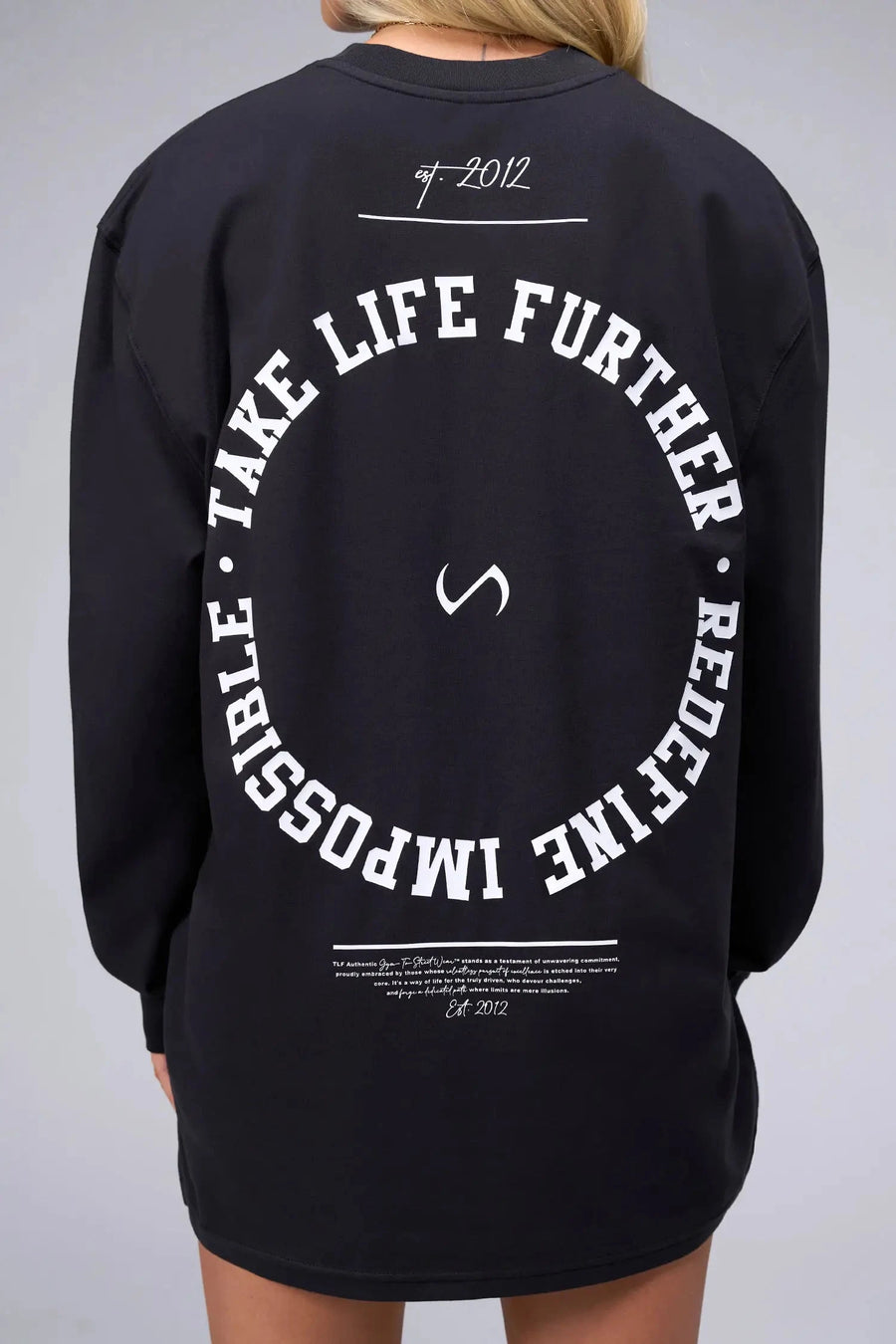 Back View of Black the TLF Redefine Original Cotton Luxe Oversized LS Tee that features a bold back graphic in an oversized fit. 