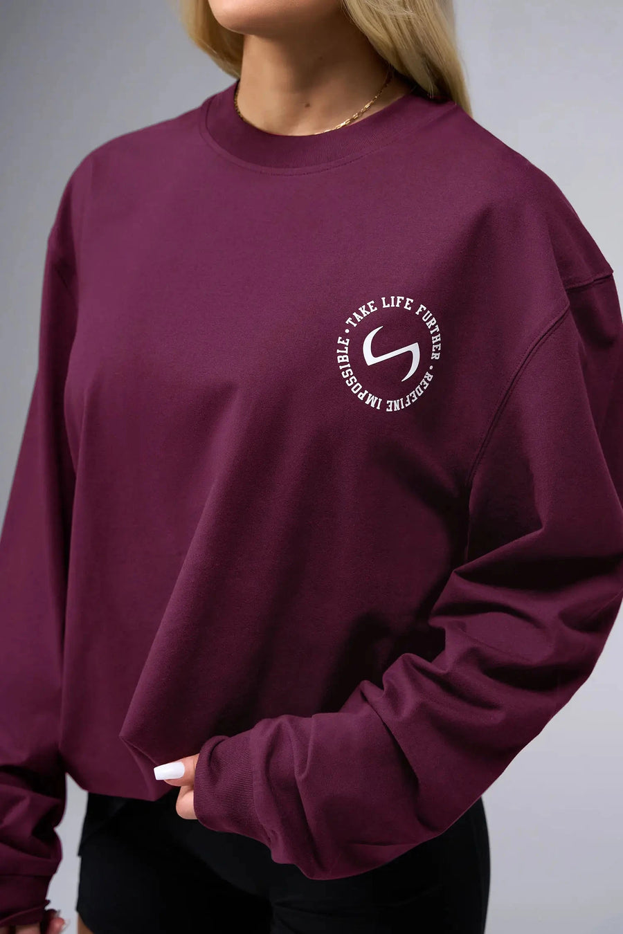 Front View of Red the TLF Redefine Original Cotton Luxe Oversized LS Tee that features a bold back graphic in an oversized fit. 